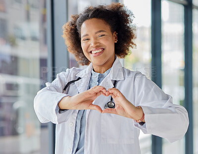 Buy stock photo Black woman, heart and hands of doctor in portrait for healthcare, wellness and kindness. Happy female cardiology worker, finger shape and trust for love emoji, icon and thank you in medical hospital