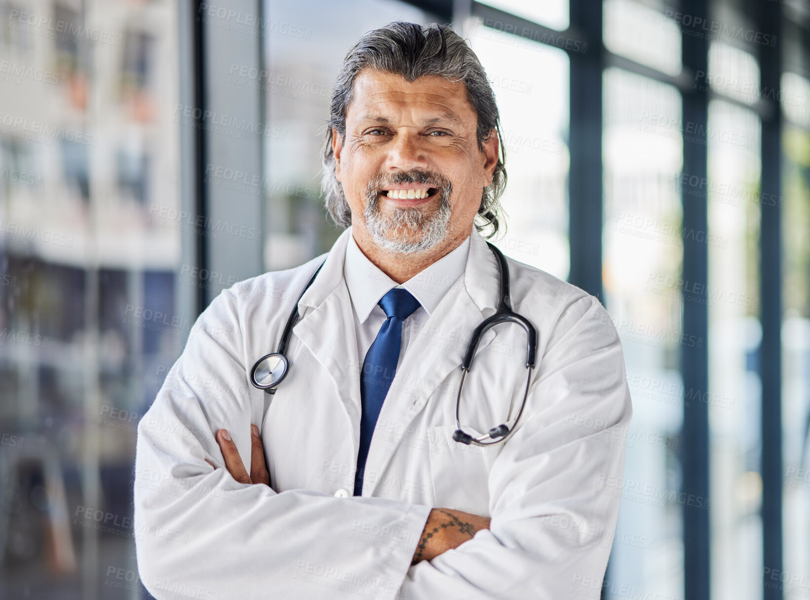 Buy stock photo Portrait, man and doctor with arms crossed, smile and surgeon with confidence, career and medicine. Face, mature person and medical professional in a hospital, healthcare expert and happy employee