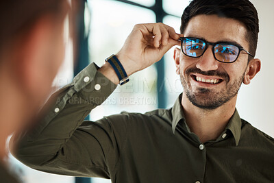 Buy stock photo Face, man and smile with glasses in mirror for vision, eyesight and prescription lens. Happy male customer with choice of frame for designer eyewear, optical fashion and assessment in eye care clinic