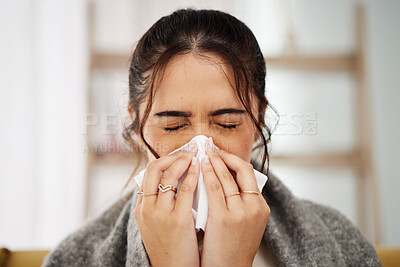 Tissue, nose and sick woman sneezing in living room with allergy, cold or flu in her home. Hay fever, sinusitis and female with viral infection, problem or health crisis in lounge with congestion