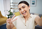 Face of woman, portrait and peace for selfie in home, video call and live streaming vlog in living room. Happy young gen z girl show v sign, hand emoji and memory for profile picture on social media