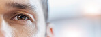 Closeup eye, portrait and a man with mockup for vision, healthcare and banner of contact lens. Focus, space and face of an optometry patient advertising health and wellness of eyesight with bokeh