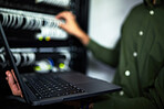 Server room maintenance, laptop and technician at work for cyber security and building network. Programming, coding and a person or it worker with a computer for a connection system in the workplace
