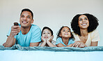 Mom, dad and children on bed, watching tv and smile for comedy, funny movie or cartoon in family house. Happy parents, kids and watch television show with streaming, subscription and relax together