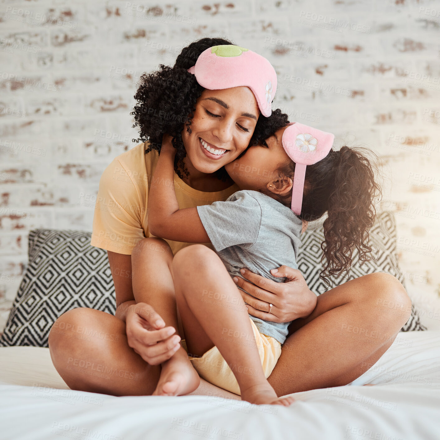 Buy stock photo Love, kiss and mother with child on bed for bonding, quality time and affection in morning. Family home, happiness and mom embrace daughter after sleeping, dreaming and relax in bedroom together