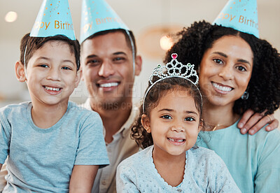 Family home, parents and kids in portrait for birthday, party and happy together for celebration. Mother, father and young children with smile, hat and excited with care, love and event in house