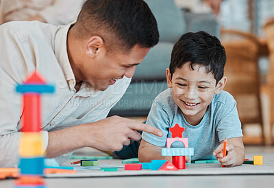 Buy stock photo Dad, child and toys, playing on floor of living room and bonding with quality time together in family home. Learning, fun and happy father with son, building block games and smile with education.