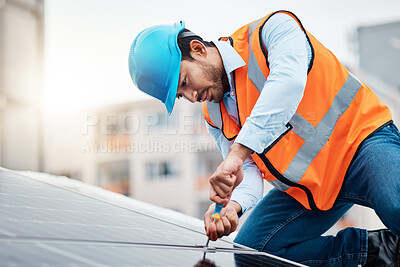 Buy stock photo Solar panels, tool and male engineer on a rooftop doing maintenance or repairs with screwdriver. Renovation, handyman and zoom of an industrial worker working on eco friendly construction on building