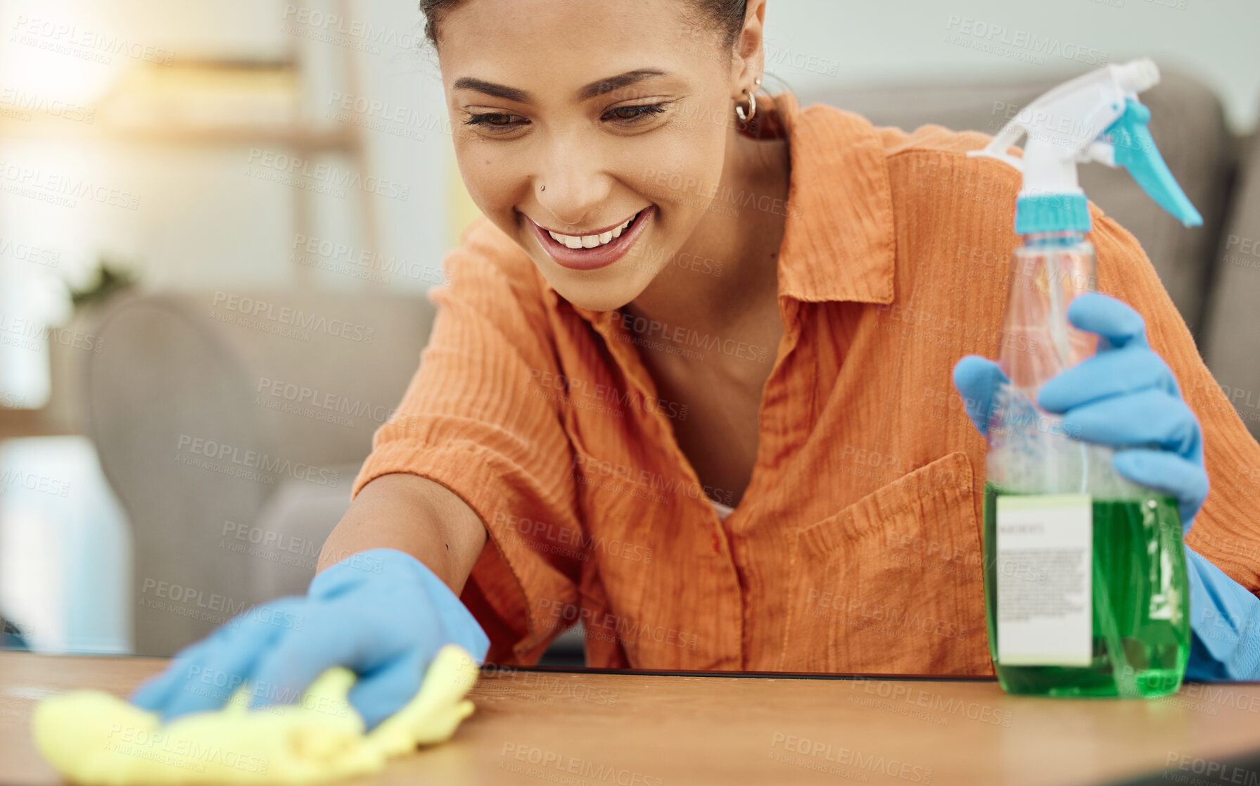 Buy stock photo Spray, woman and smile for cleaning table, furniture and housekeeping services at home. Female cleaner wipe surface with cloth, bottle of chemical product and disinfection of dust, bacteria and dirt