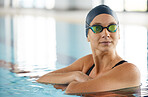 Swimming, thinking and a woman on a break in a pool from training, competition or fitness. Idea, serious and a professional athlete swimmer or girl in the water for exercise, cardio or sports