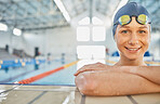 Portrait, woman in water and swimming pool for competition, training or professional sports or exercise in gym or club. Swimmer, smile or happy from winning, achievement or wellness in cardio workout