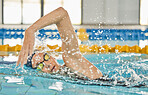 Race, water splash or girl training in swimming pool for a sports competition, exercise or cardio workout. Female swimmer, wellness or healthy woman exercising with fitness speed in practice game