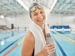 Portrait, swimming pool and woman smile with bottle for exercise, workout or training. Face, happy and swim athlete with water for nutrition, fitness and healthy body, wellness or hydration in Canada