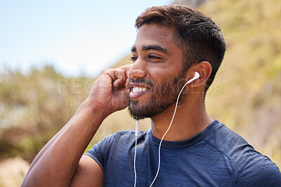 Fitness, happy man or runner with music in training, wellness or cardio exercise outdoors in nature. Headphones, radio audio or healthy athlete listening or streaming podcast to start running workout