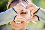 Nature, portrait and heart hands of a woman for exercise, training and an outdoor workout. Smile, closeup and face of a young athlete or runner with a gesture for love of fitness or running in a park