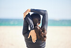 Woman, fitness and back stretching body for exercise, workout or outdoor running on beach. Rear view of female person, athlete or runner in warm up, preparation or getting ready for cardio training