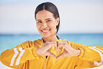 Happy woman, portrait and heart hands on beach for love, care or support in trust, health or romance. Outdoor female person with emoji, symbol or icon for like or wellness in peace, sign or emoticon