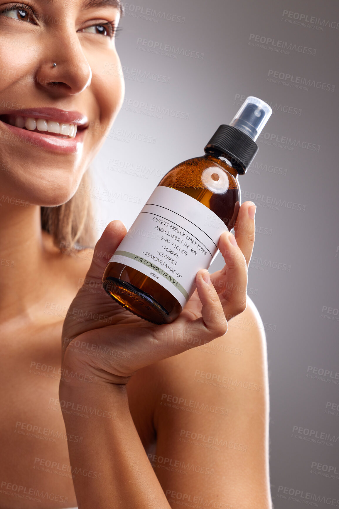 Buy stock photo Beauty, happy woman and cleanse wash spray for morning bathroom routine, skincare hydration treatment or facial wellness. Self care product, liquid cosmetics toner or studio person on grey background