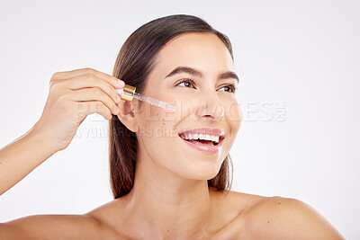 Buy stock photo Facial skincare, smile and woman with a serum, cosmetics or happiness on a white studio background. Female person, model or girl with essential oil, retinol product or dermatology with natural beauty