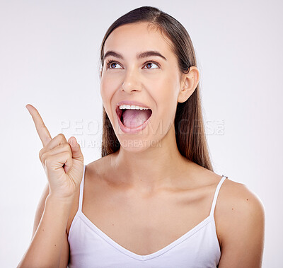 Buy stock photo Pointing, surprise and woman excited, announcement and happiness on a white studio background. Wow face, person or model with shock, hand sign and choice with ideas, promotion and news with promotion