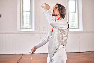 Buy stock photo Fencing, sports and man drinking water after training, fitness or workout with sword in club. Bottle, fencer or athlete with beverage after exercise with liquid for nutrition, body health or wellness