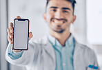 Happy man, doctor and phone mockup screen for healthcare advertising or marketing at the hospital. Male person or medical professional show mobile smartphone display for Telehealth or app at clinic