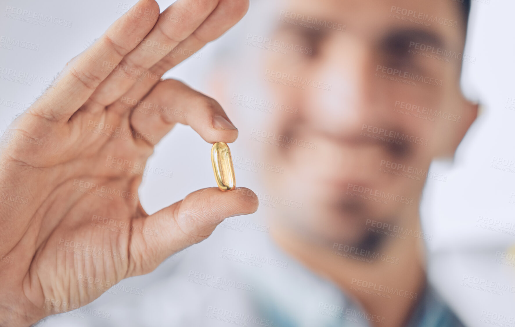 Buy stock photo Man, hand of doctor and pill, pharmaceutical drugs and treatment of illness at hospital with blurred background. Healthcare, medicine and medical professional with gold capsule to help with health.