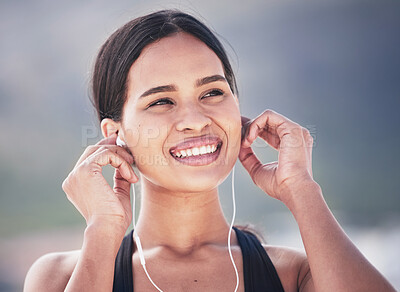 Buy stock photo Fitness, smile and woman with music earphones outdoor for running, training and sports routine on blurred background. Exercise, podcast and happy female runner with radio, track and audio motivation