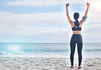 Fitness, celebration and woman with arms up at beach, mockup and winning achievement in nature. Ocean, goals and exercise girl for workout motivation, victory and blue sky with waves in natural space