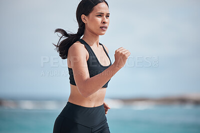 Buy stock photo Running, exercise and woman at a beach for fitness, training and body performance workout for healthy energy. Sports, wellness and female runner at the sea for resilience, challenge or ocean run