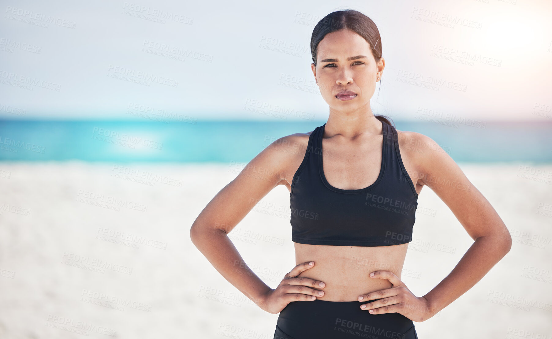 Buy stock photo Portrait, fitness and serious woman at a beach for training, sports and exercise, running and workout in nature. Ocean, face and female runner at the sea for wellness, health and resilient mindset