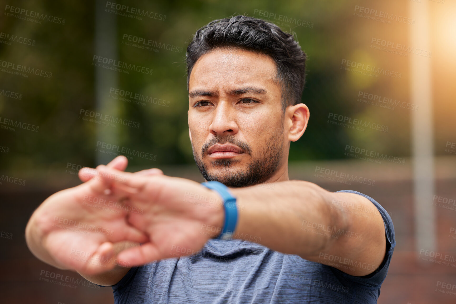 Buy stock photo Serious, fitness or man stretching arms in exercise, training or healthy sports outdoor. Face of strong asian athlete focus to warm up in workout, performance or thinking of mobility, energy or power