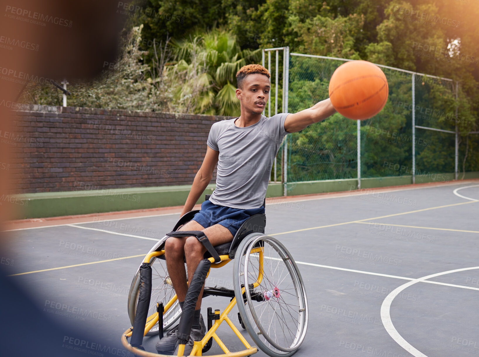 Buy stock photo Basketball, wheelchair and man with sports ball at outdoor court for fitness, training and cardio. Exercise and person with a disability at a park for game, workout and weekend fun or active match