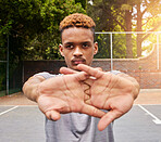 Sports, basketball and man stretching on court for competition, training or fitness games. Face of serious male athlete, player and warm up arms for workout, thinking of performance action or contest