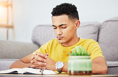 Buy stock photo Prayer, peace and bible with man in living room for worship, spiritual and Christian faith. Hope, God and belief with person praying with holy book at home for religion, thinking and gratitude