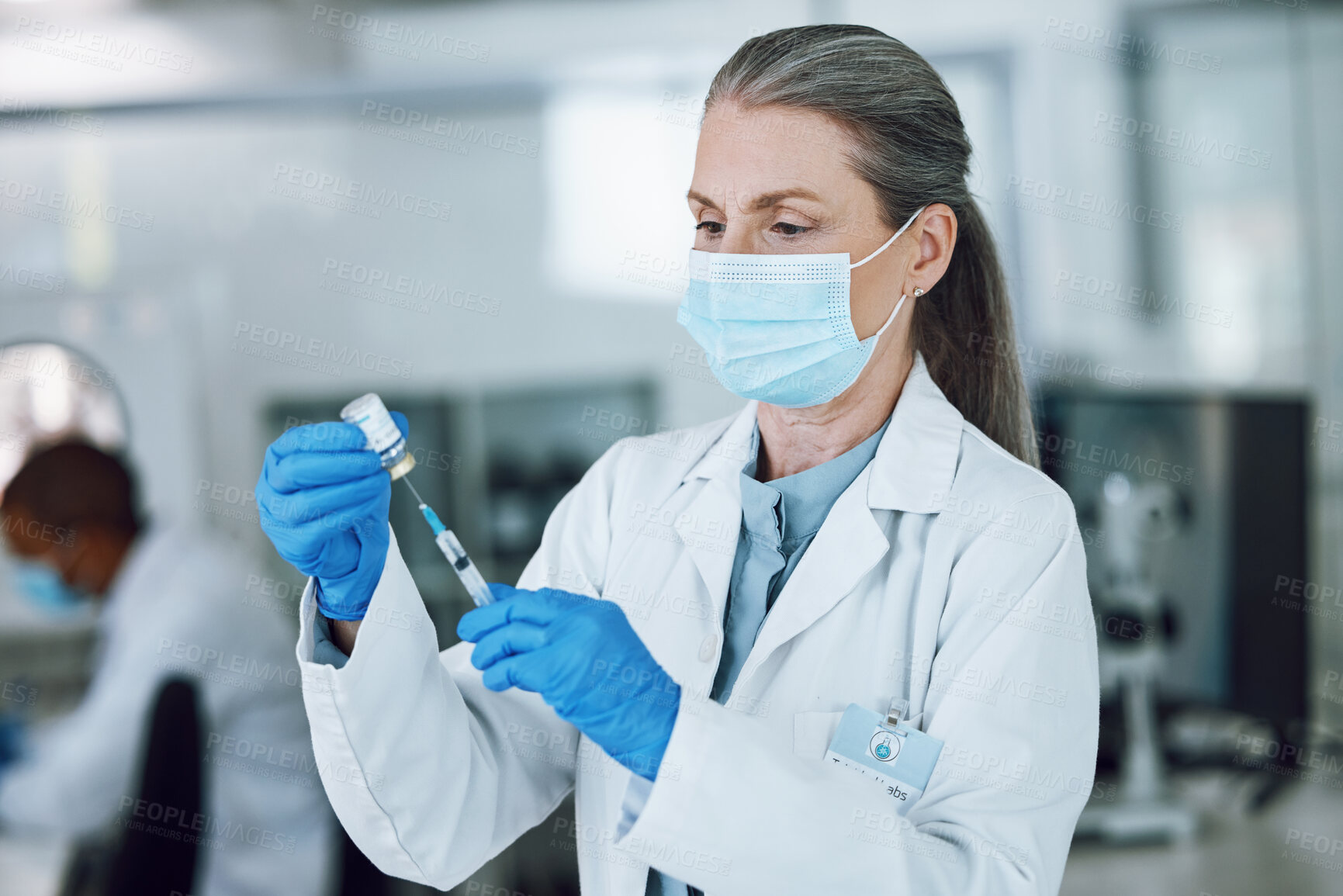 Buy stock photo Woman doctor, scientist with mask, needle and vaccine bottle at hospital laboratory for covid research. Healthcare, medicine and medical professional with sample syringe for corona vaccination in lab