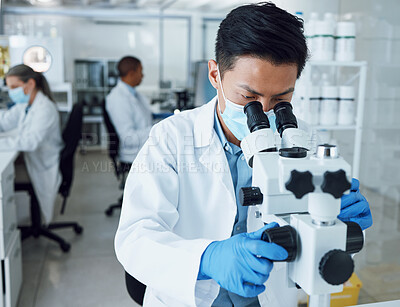 Buy stock photo Microscope, science and asian man with mask in laboratory to review virus particles, medical test and biotechnology. Scientist, research and investigation of innovation, dna analysis and results