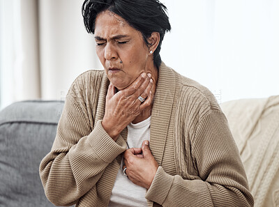 Buy stock photo Senior woman, cough and sick on sofa in home, chest pain and pneumonia with tuberculosis or choke. Pensioner, mature lady or sore throat with lung infection, breathing problem and choking with asthma