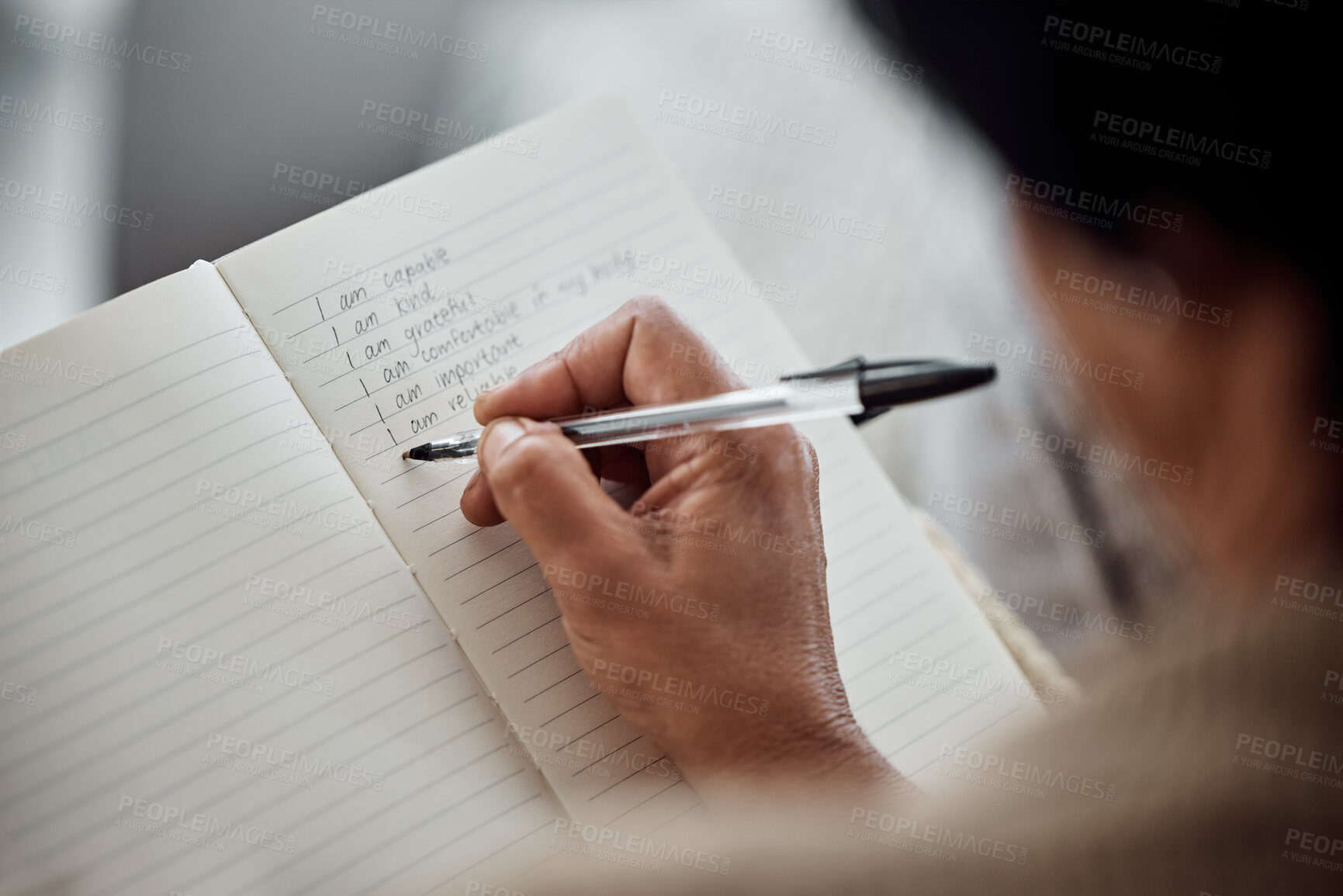 Buy stock photo Hand, book and writing for affirmation with an old woman in her home for support or motivation. Journal, diary or notebook with a senior person holding a pen for self confidence during retirement