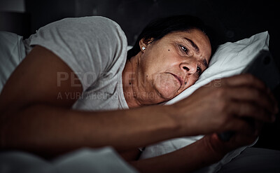 Buy stock photo Insomnia, night and phone with old woman in bed for social media, thinking and communication. Tired, fatigue and relax with senior person in bedroom at home for mobile app, streaming and contact