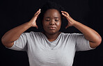 Frustrated black woman, stress and anxiety in studio with fear of crazy memory, trauma or noise in mind on dark background. Face of confused model in burnout, brain fog or depression of mental health