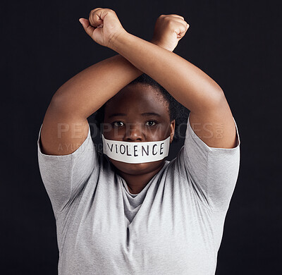 Buy stock photo Portrait, freedom and a black woman in protest of domestic violence on a dark background. Censorship, gender equality or empowerment with a serious young female person in studio for human rights