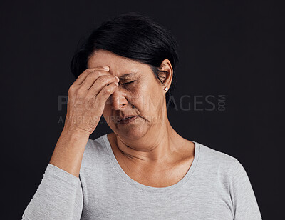 Frustrated senior woman, headache and anxiety in studio for depression, debt and confused on black background. Face of person with burnout, stress and pain of mental health problem, mistake or crisis