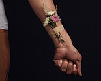 Hands, bandage and flowers for health, healing and herbal therapy on a black background mockup in studio. Plaster, person and organic plant for alternative medicine, wellness and natural healthcare.