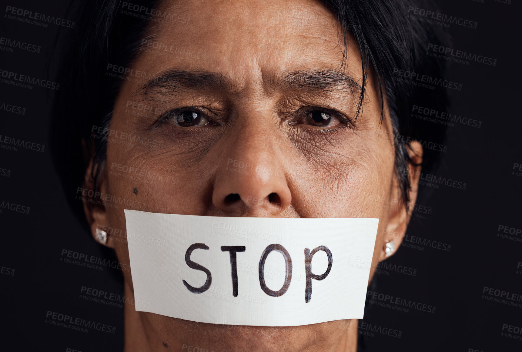 Buy stock photo Portrait, stop and silence with a woman in studio on a black background for gender equality or domestic violence. Face, censorship or abuse and a scared female victim with her mouth covered closeup