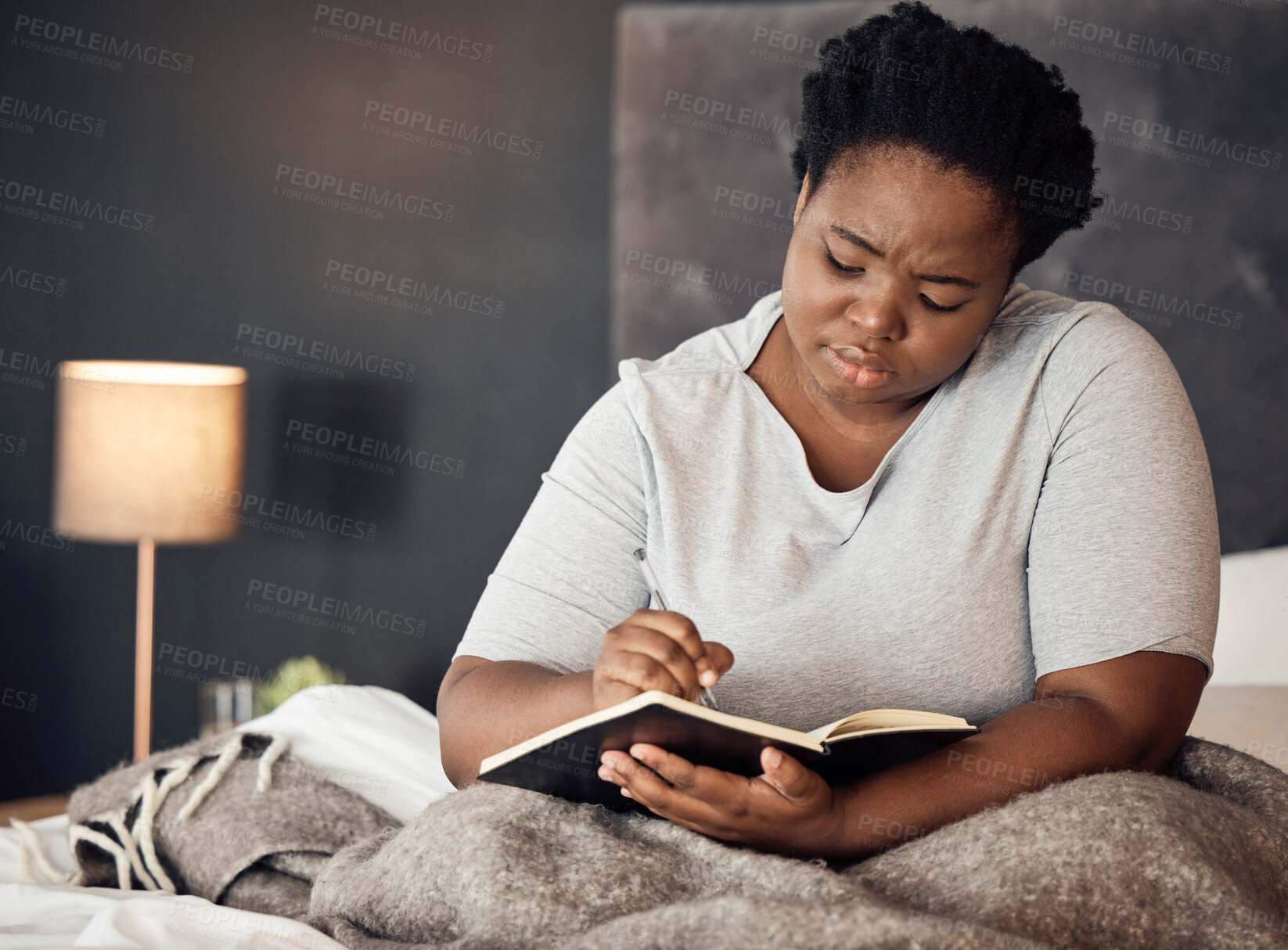 Buy stock photo Bedroom, diary and black woman with depression, writing and stress management with sadness, burnout and home. Journal for mental health, female person and girl with a notebook, depressed and anxiety