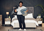 Black woman, clothes in basket and cleaning bedroom, garbage bag and hygiene with portrait in bedroom. Female person, cleaner and housekeeping with smile, laundry and maintenance with morning routine