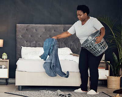 Buy stock photo Black woman, clothes with basket and cleaning bedroom, organize mess with hygiene and hospitality. Female person, cleaner and housekeeping, busy with laundry and maintenance with morning routine