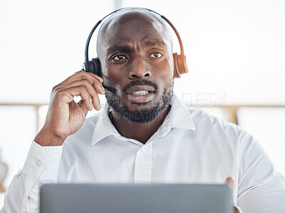 Buy stock photo Black man thinking while consulting on laptop in call center for customer service, advisory and questions. Face of serious salesman working in CRM agency for telecom solution, tech support and help