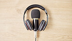 Audio, microphone and headphones on a table for a podcast, radio or broadcast. Music, above or musical gear, equipment or a mic for live streaming, musician recording or technology in an office